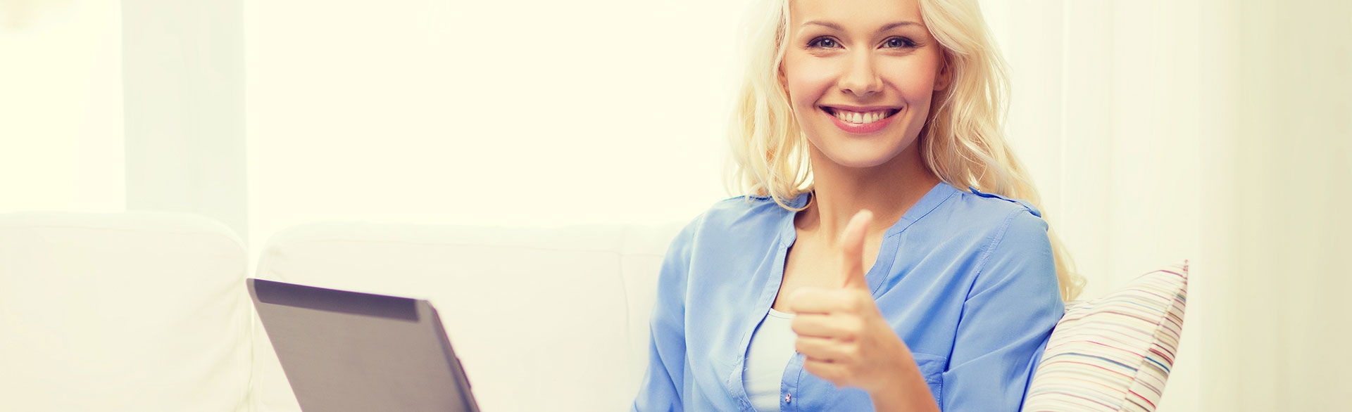 smiling woman giving a thumbs up