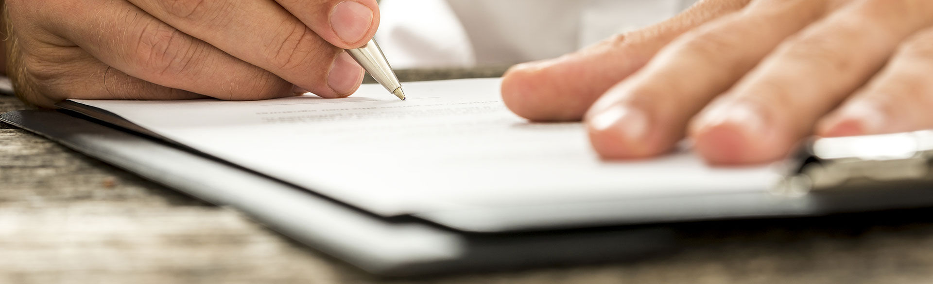 closeup of a person filling out a form