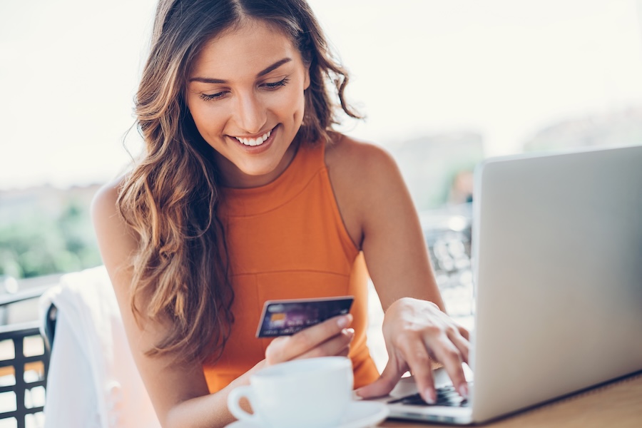 woman paying for dental costs with dental membership plan